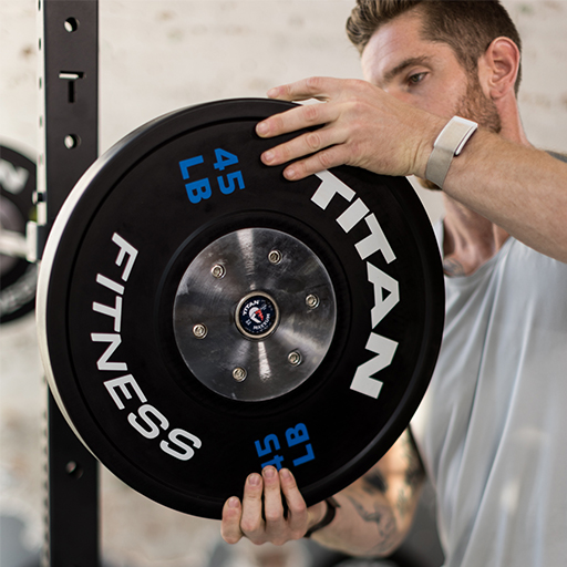 Person putting weight plates on to a barbell