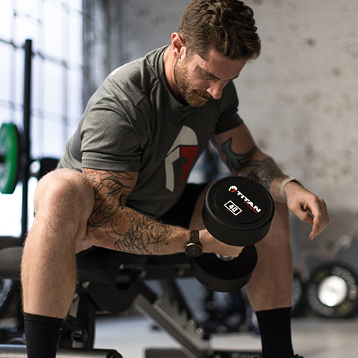 Male doing concentration curls with dumbbells