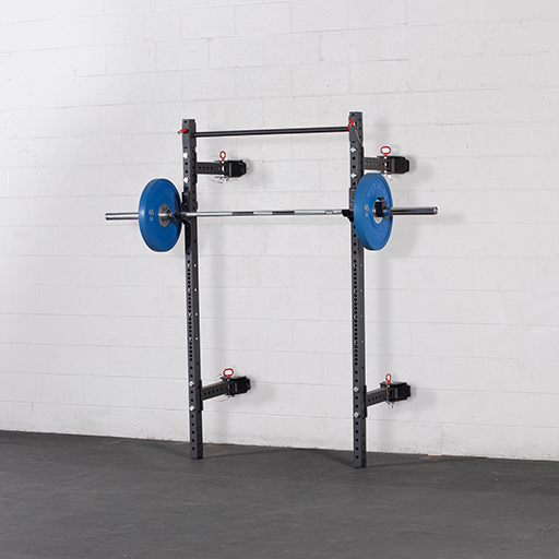 folding rack mounted on a wall with weights on it. 