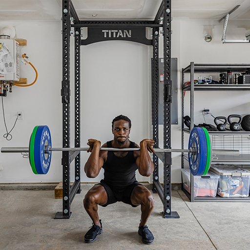 Person front squatting in a power rack