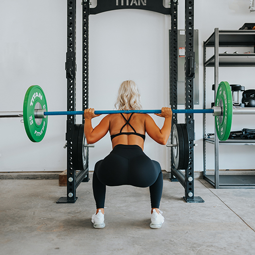 person performing a barbell squat